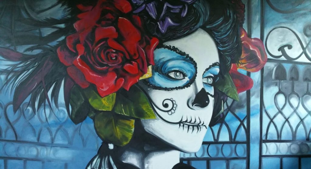 A photo of a large acrylic portrait painting celebrating 'The Day Of The Dead' face painting.