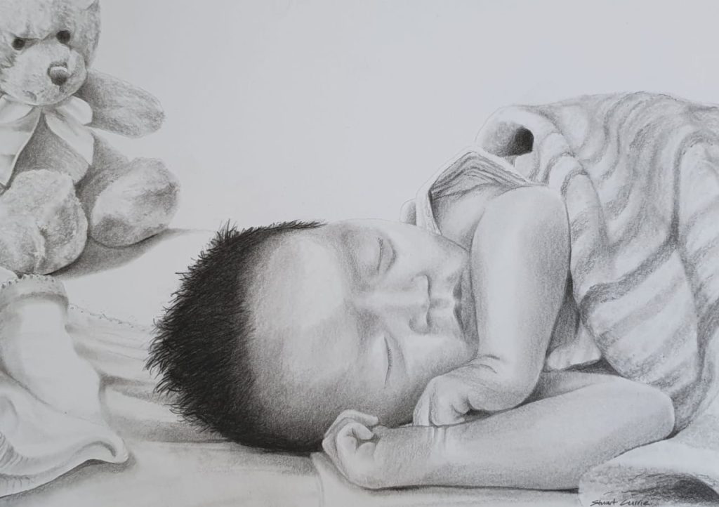 A photo of a realistic hand-drawn portrait of a baby peacefully sleeping next to a teddy bear toy.