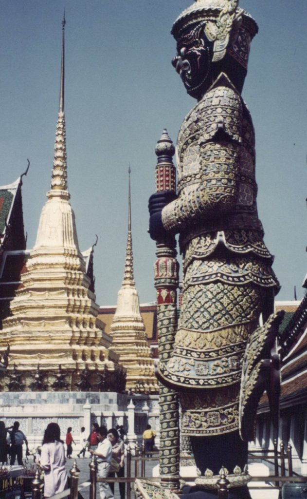 A photo of a majestic towering deity inside the Grand Palace.