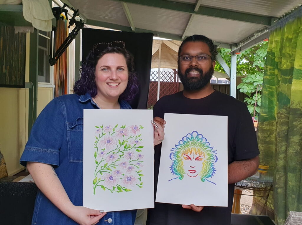 Art class students Emily and Will holding up their creations.