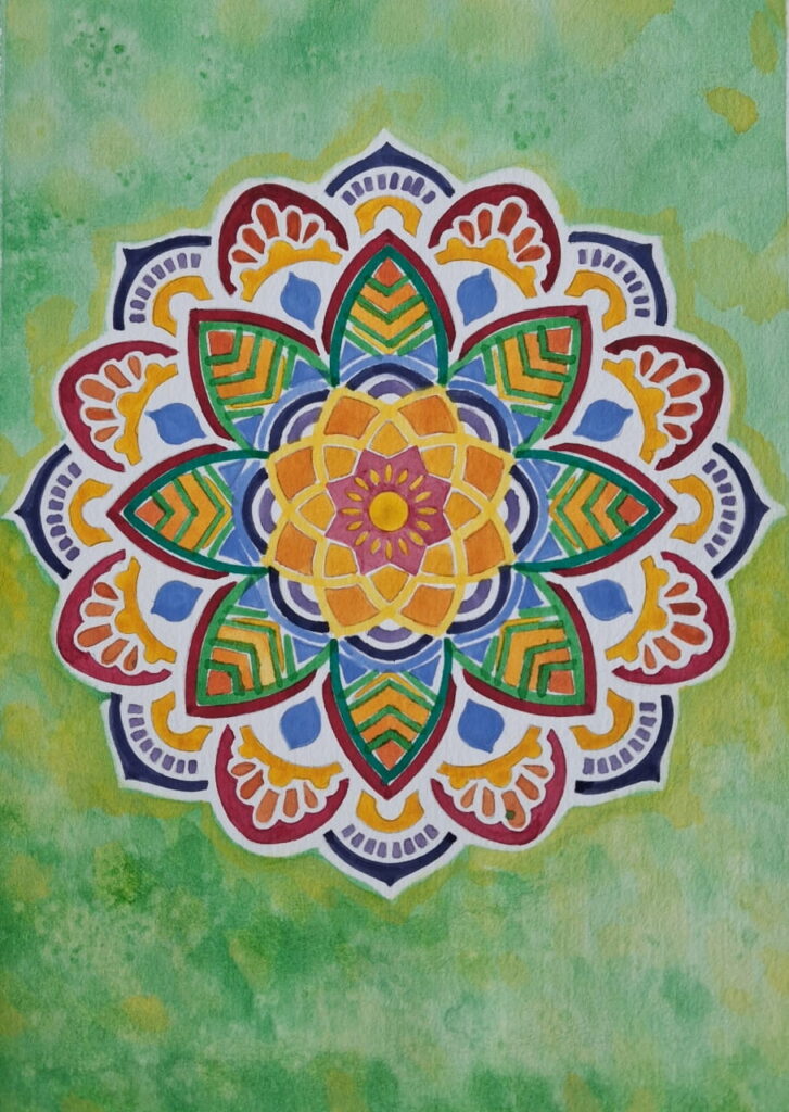 A stencil assisted watercolour painting of a mandala.